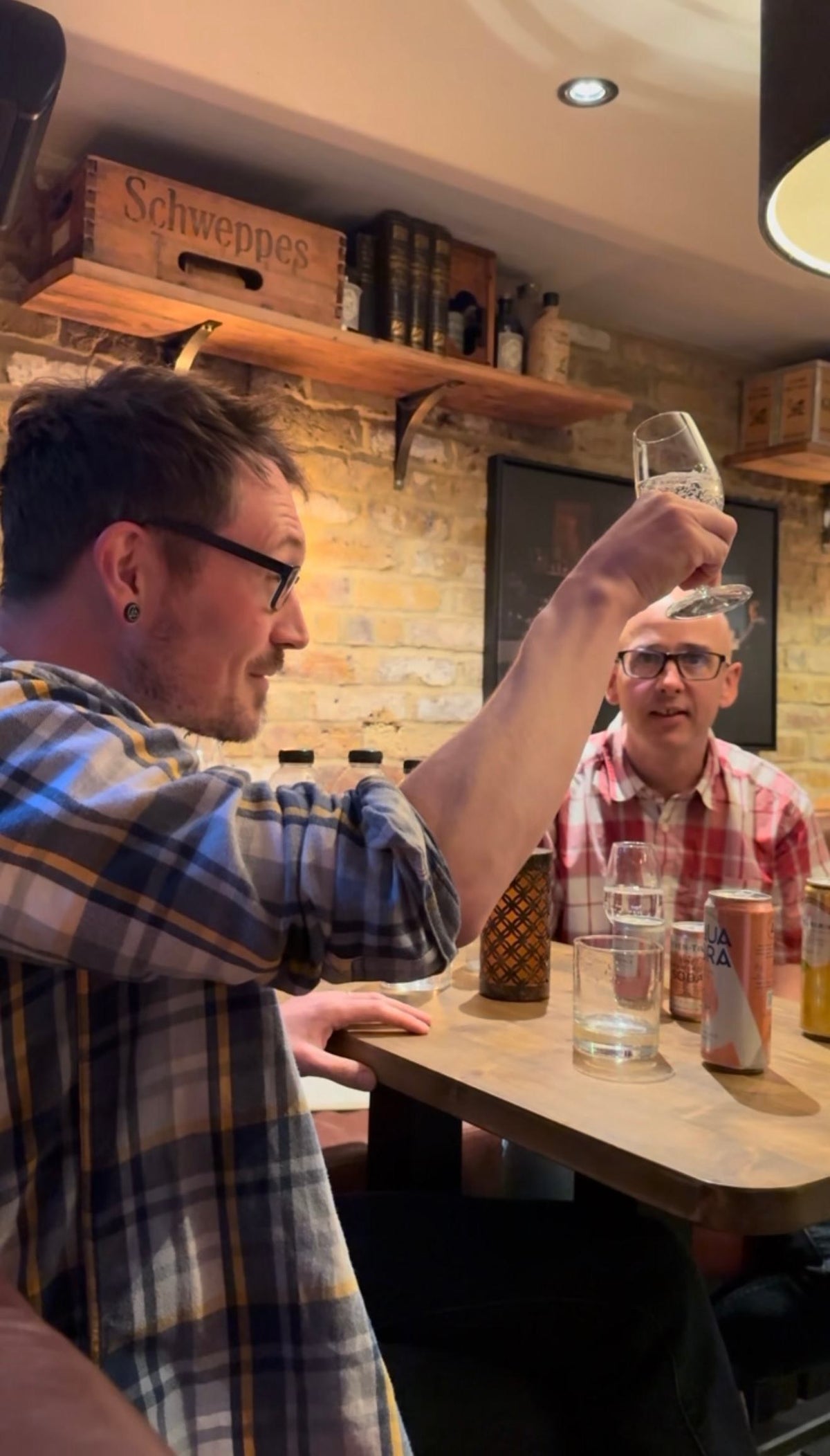 Two people examining drink samples at a table