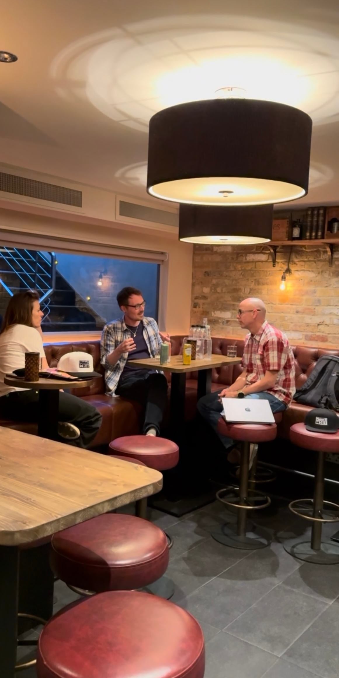 A group tasting drink samples around a table